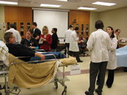 University of Missouri medical and nursing students , respiratory therapy students, health management and informatics students, and UMKC pharmacy students participate in an interdisciplinary simulation that mimics a busy emergency room.