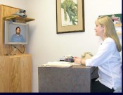 Karen Edison, director of the Center for Health Policy, talks with a patient via videoconferencing technology from the Missouri Telehealth Network. The technology is part of a grant-funded project that provides medical interpreters for patients.
